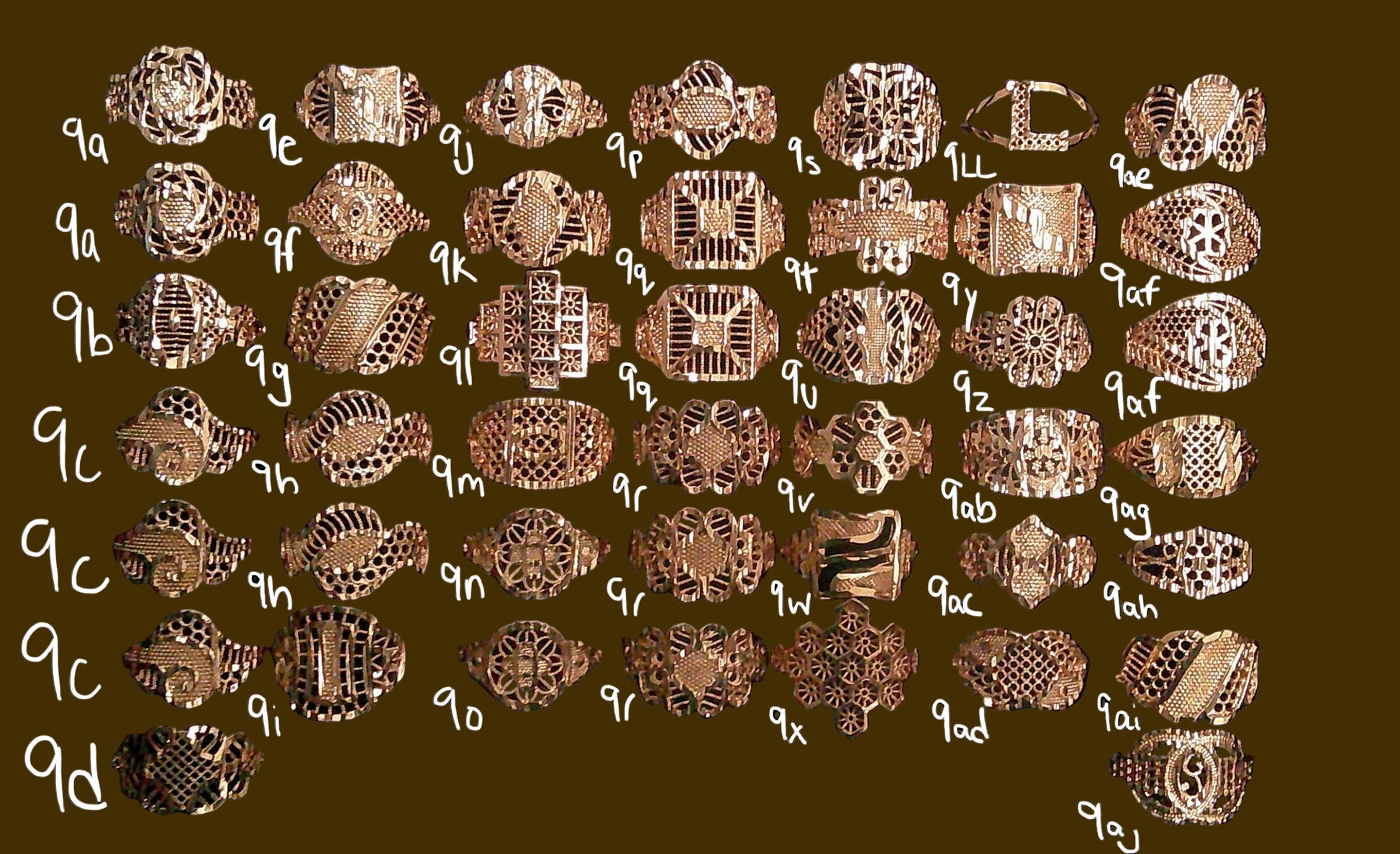 Collection of gold rings with various designs on a black background